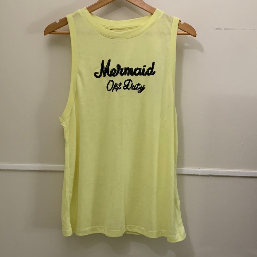 Yellow sleeveless shirt new without tags.